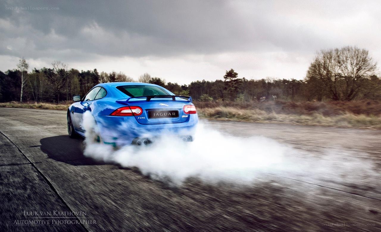 Blue Jaguar drifting on track