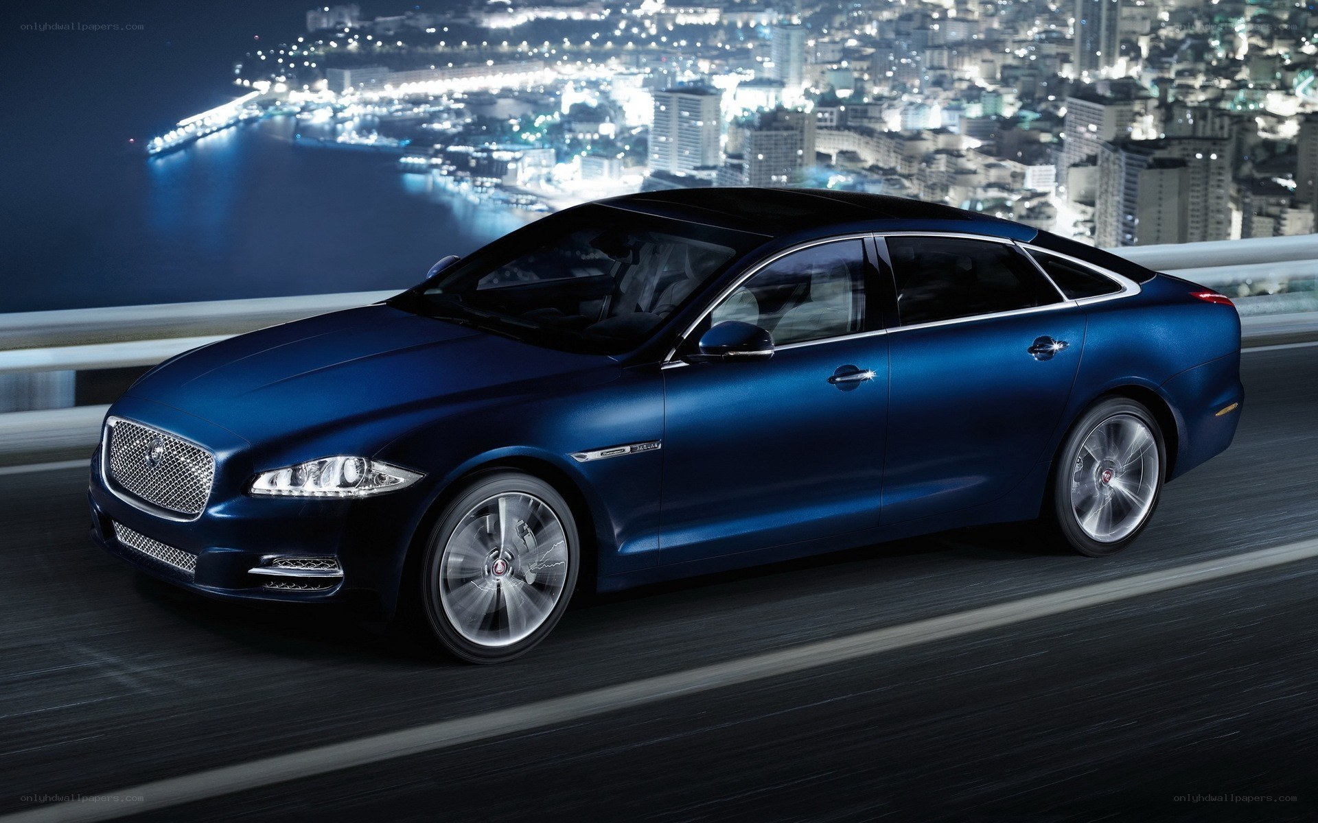 blue jaguar driving at night