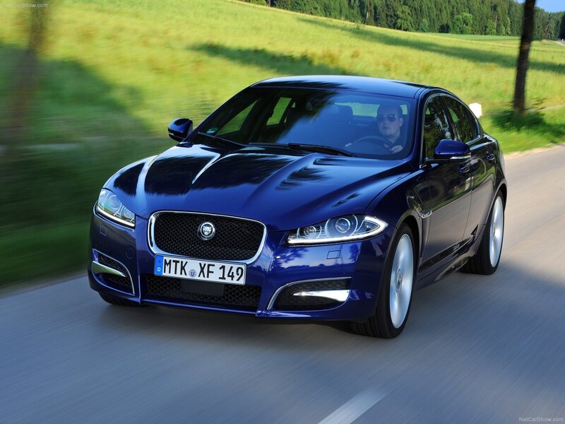 blue jaguar driving on road