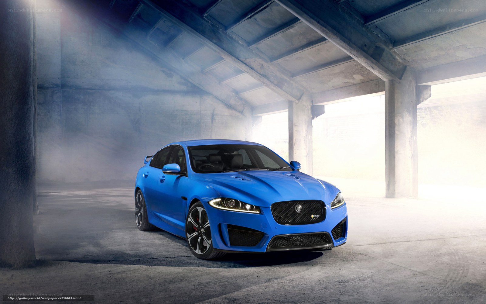 Blue Jaguar in a concrete garage