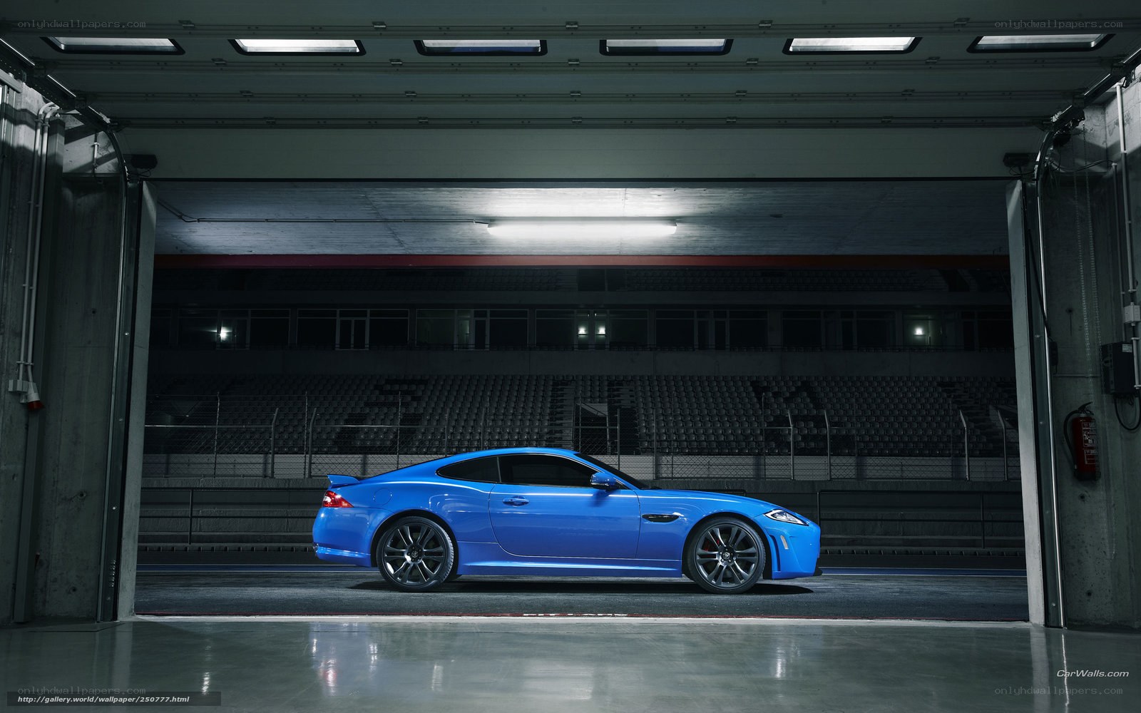 Blue Jaguar in a garage