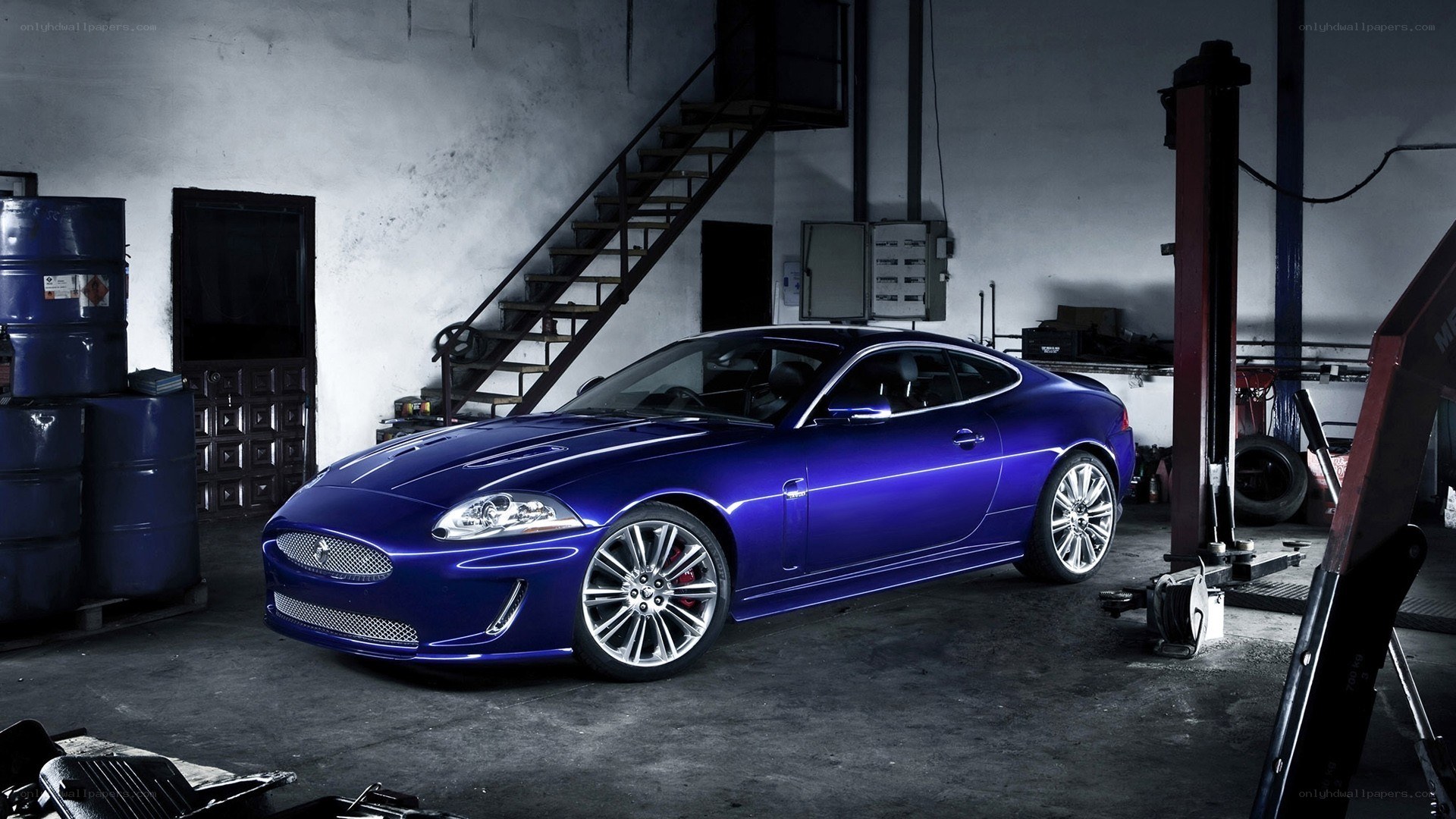 Blue Jaguar in a garage