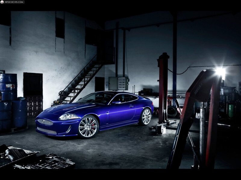 Blue Jaguar in a garage