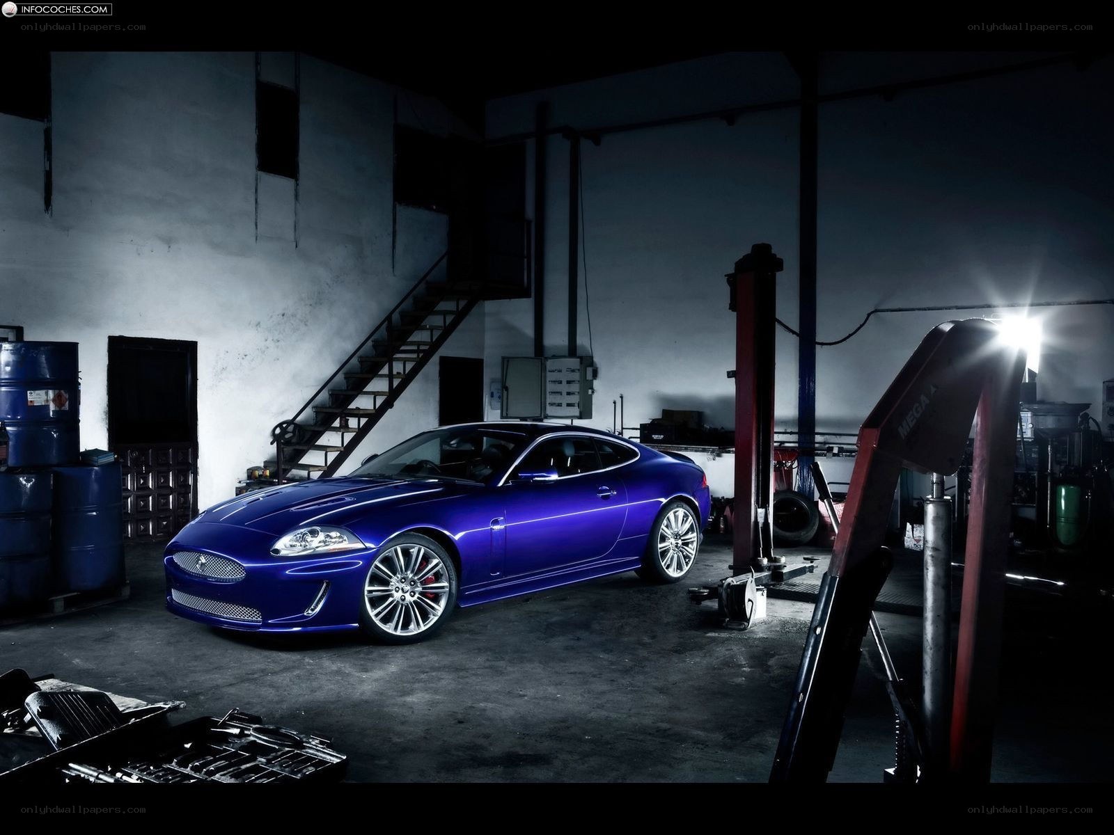 Blue Jaguar in a garage
