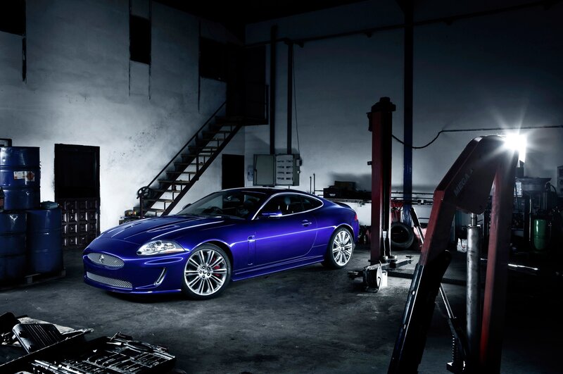 Blue Jaguar in a garage