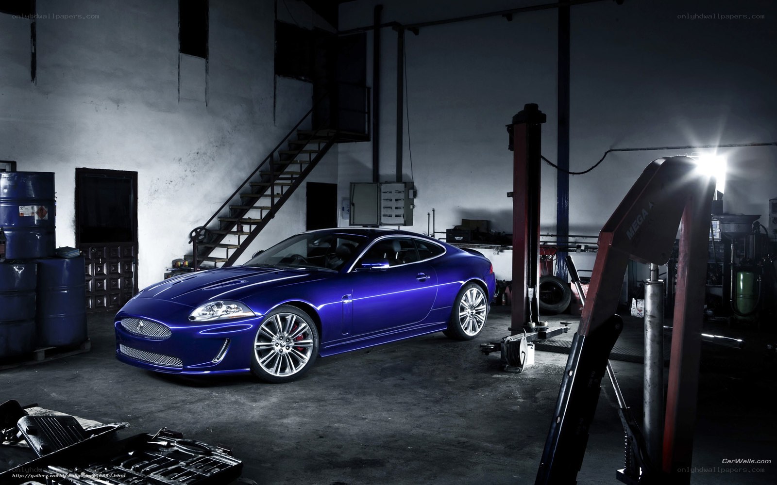 Blue Jaguar in a garage