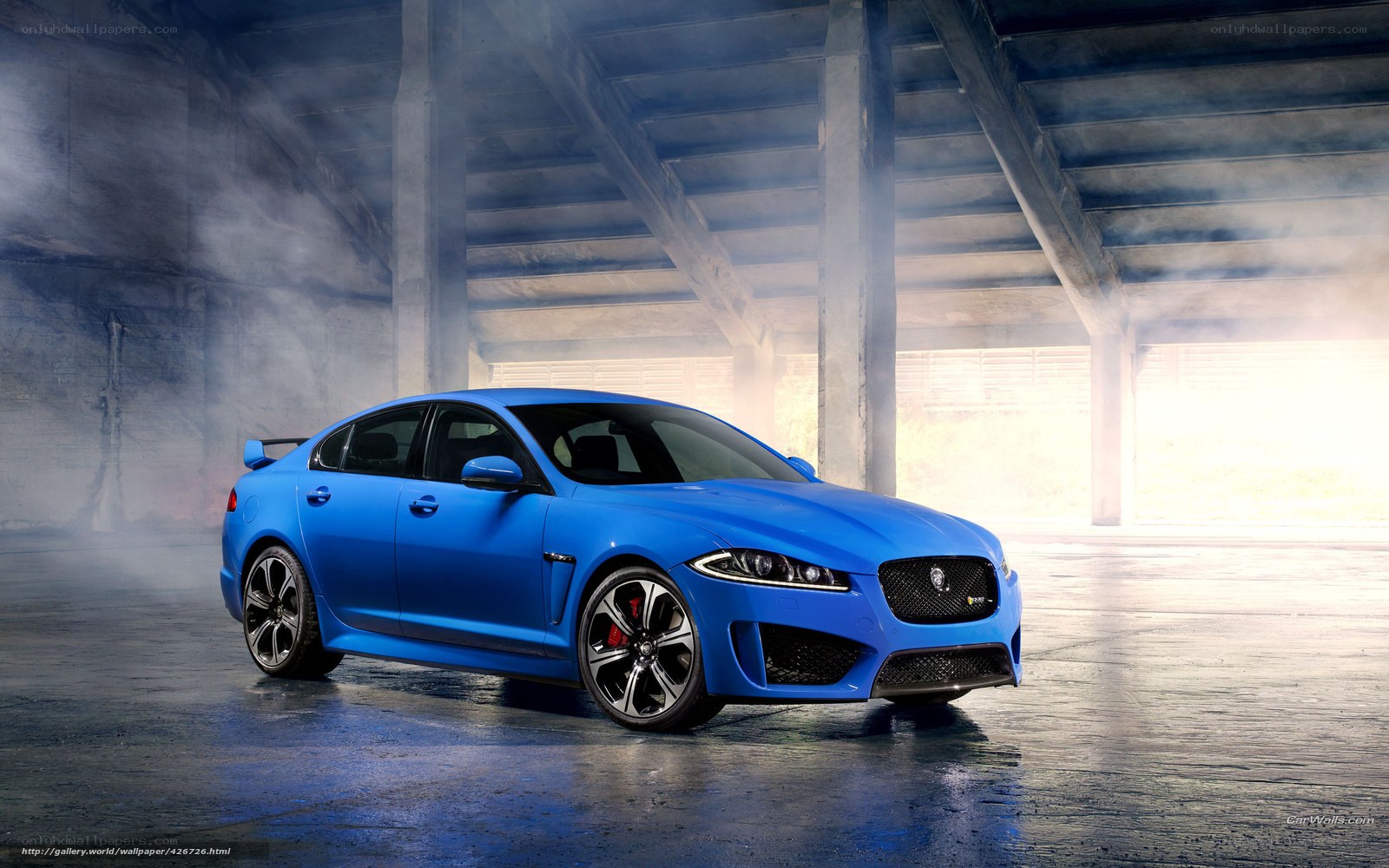 blue jaguar in a smoky garage