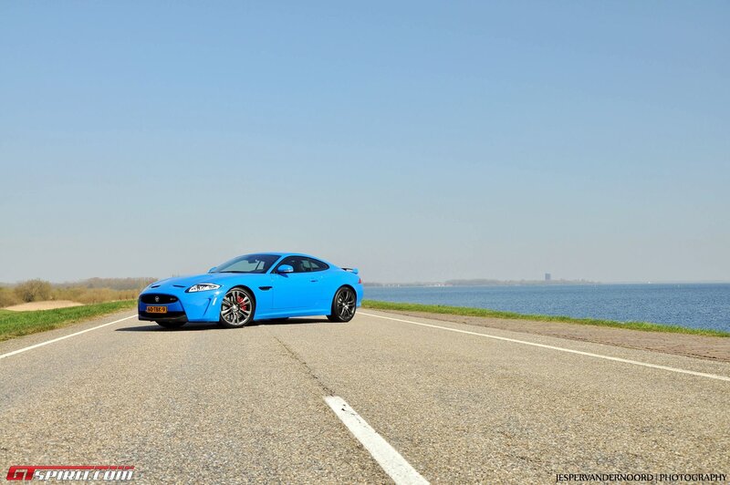 Blue Jaguar on a coastal road
