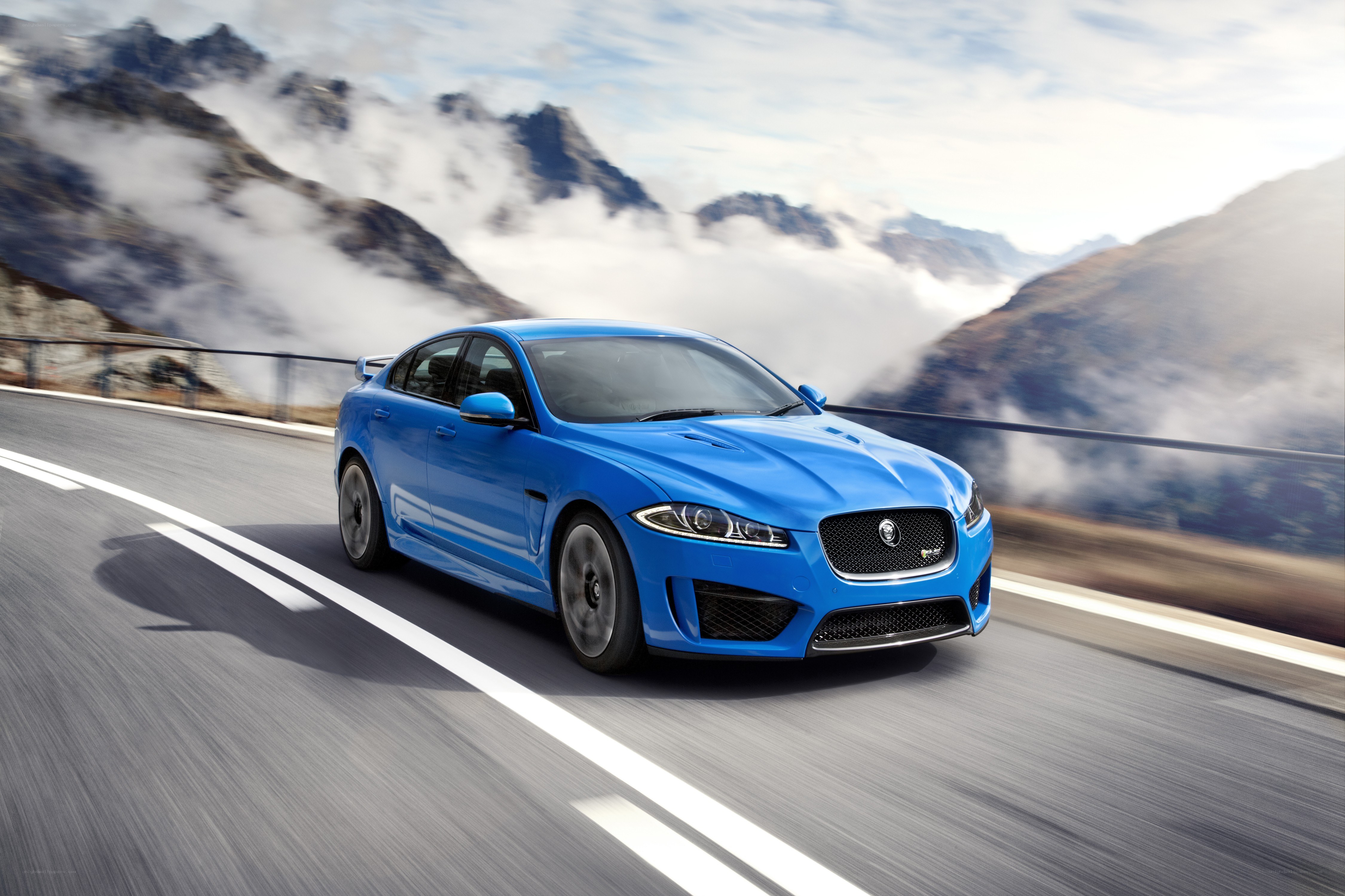 Blue Jaguar on mountain road
