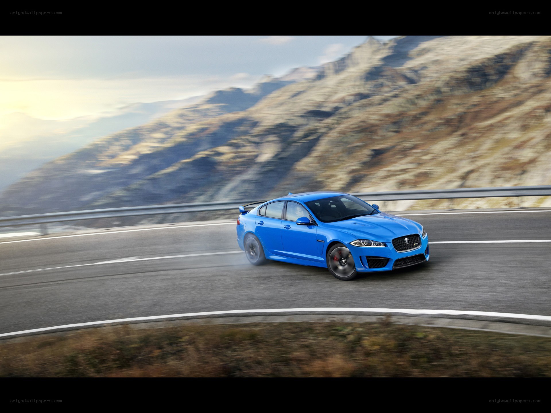 Blue Jaguar on mountain road
