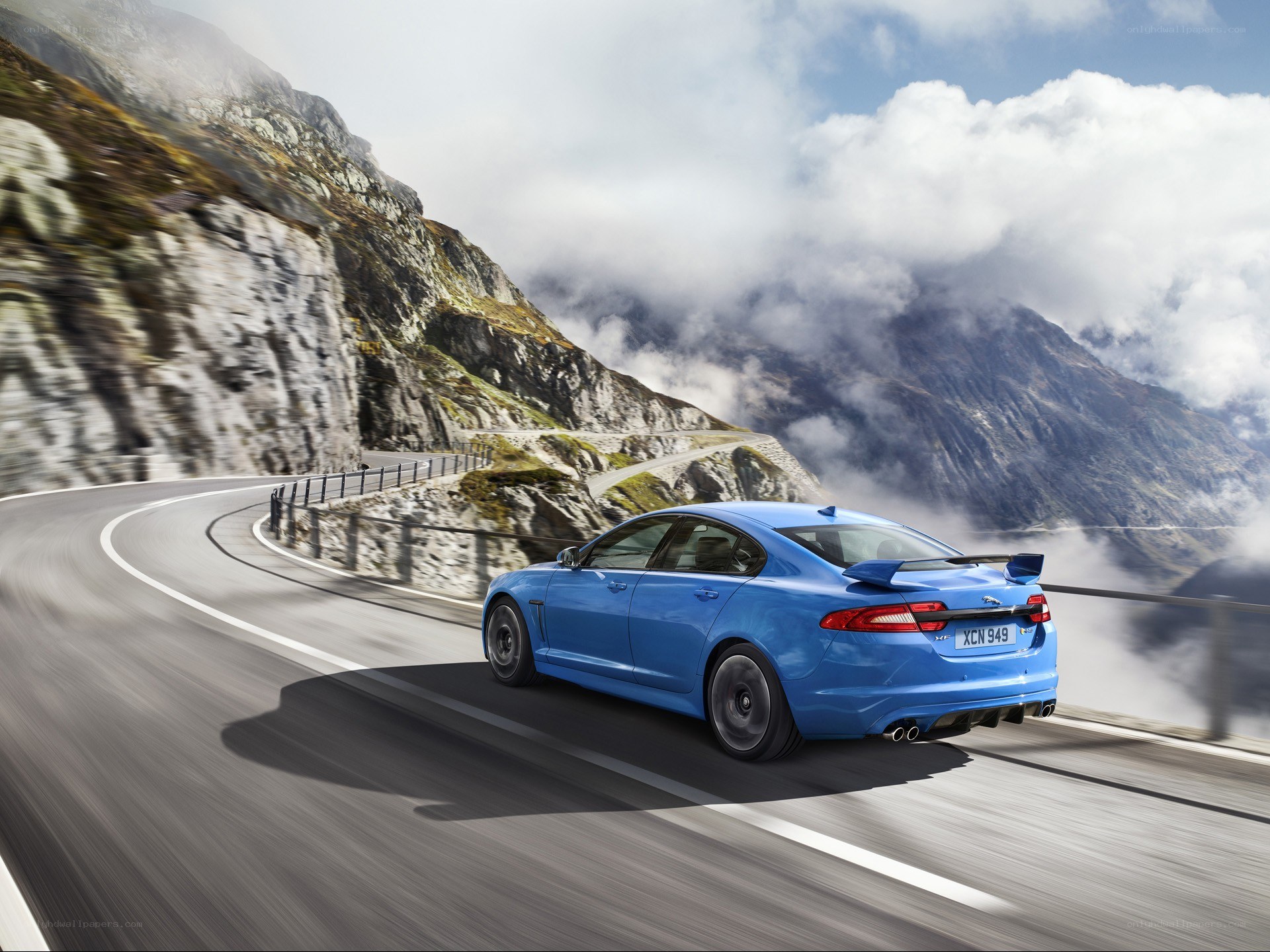 Blue Jaguar on mountain road
