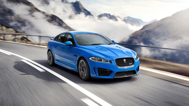 blue jaguar on mountain road