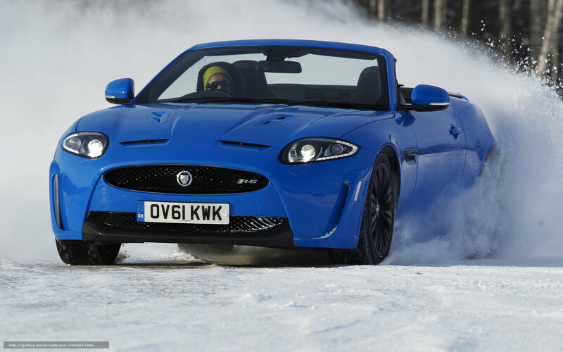 blue jaguar on snowy road