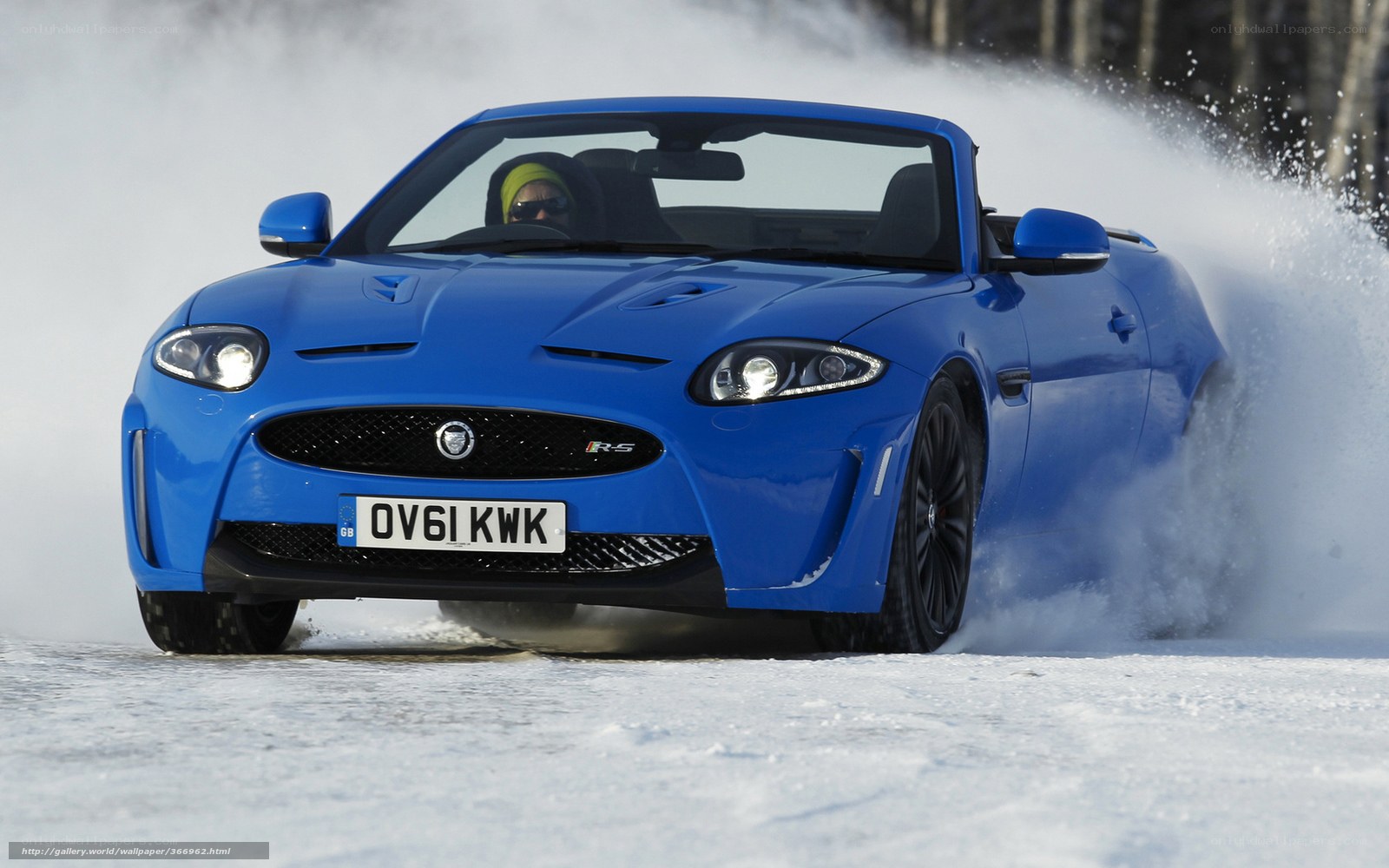 blue jaguar on snowy road
