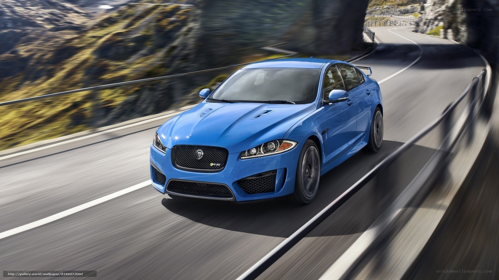 blue jaguar on winding road