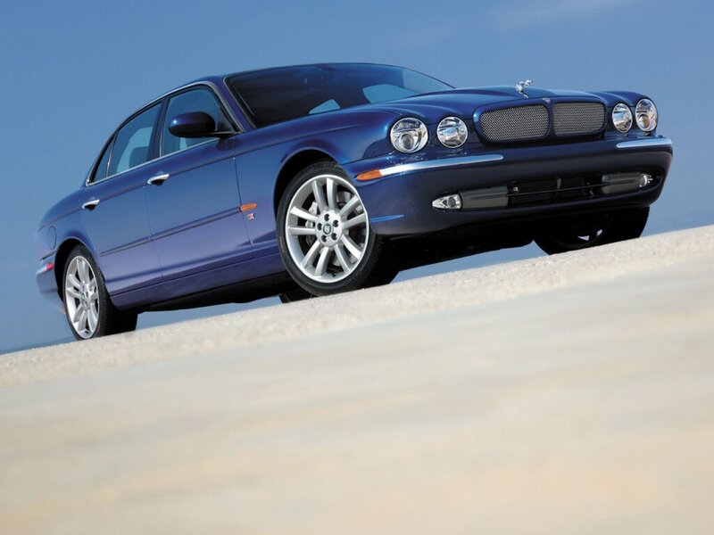 blue jaguar sedan on sand