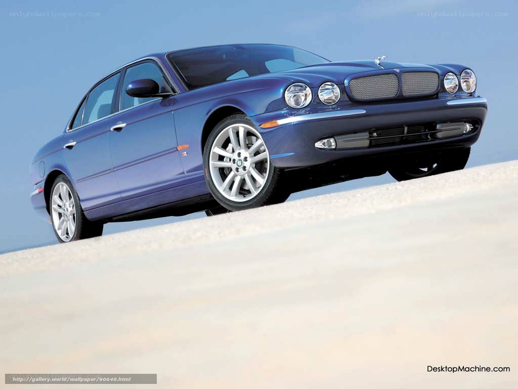 blue jaguar sedan on sand