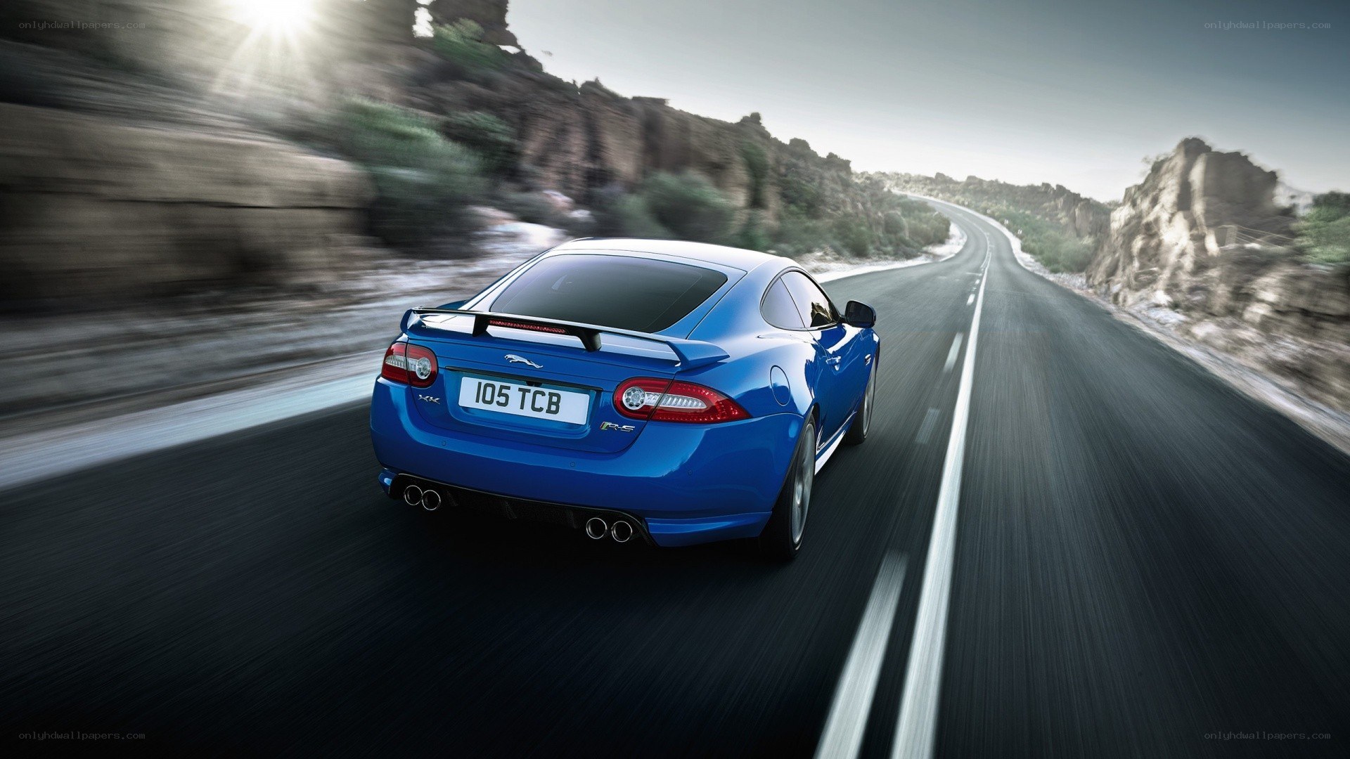 blue jaguar speeding on road
