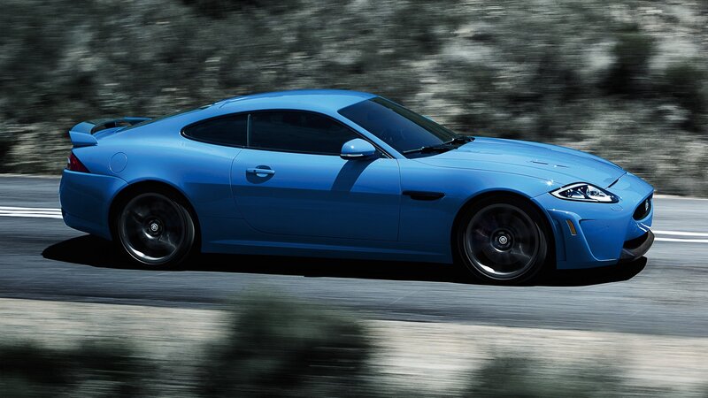 blue jaguar sports car in motion