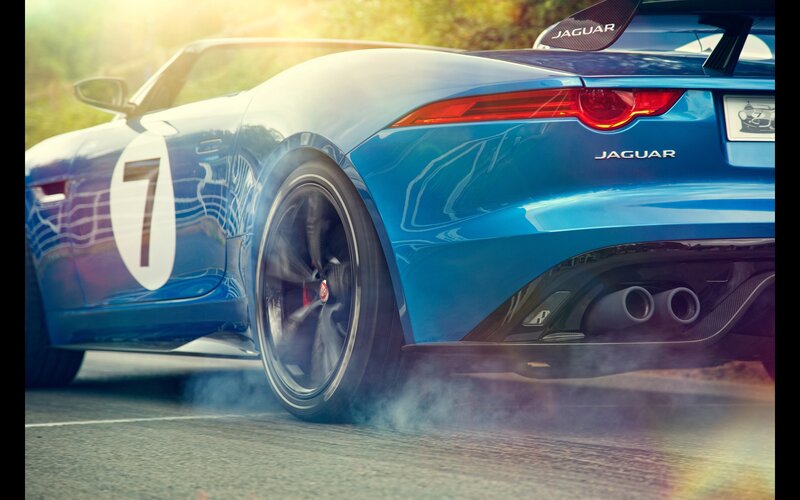 Blue Jaguar sports car in motion