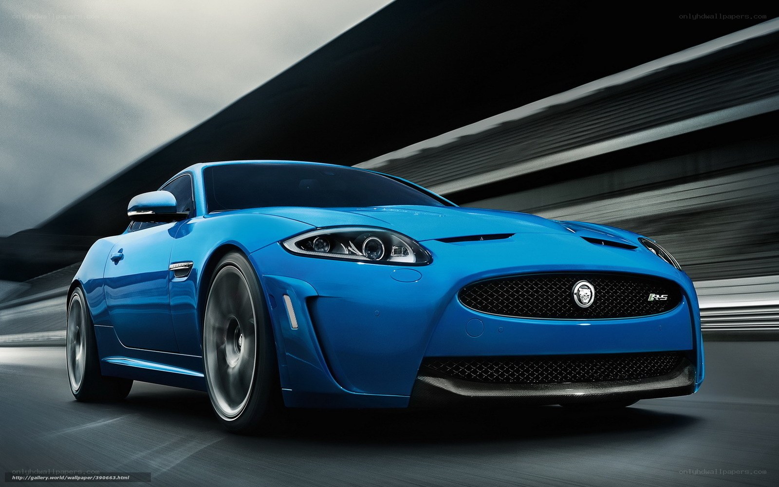 Blue Jaguar sports car in motion
