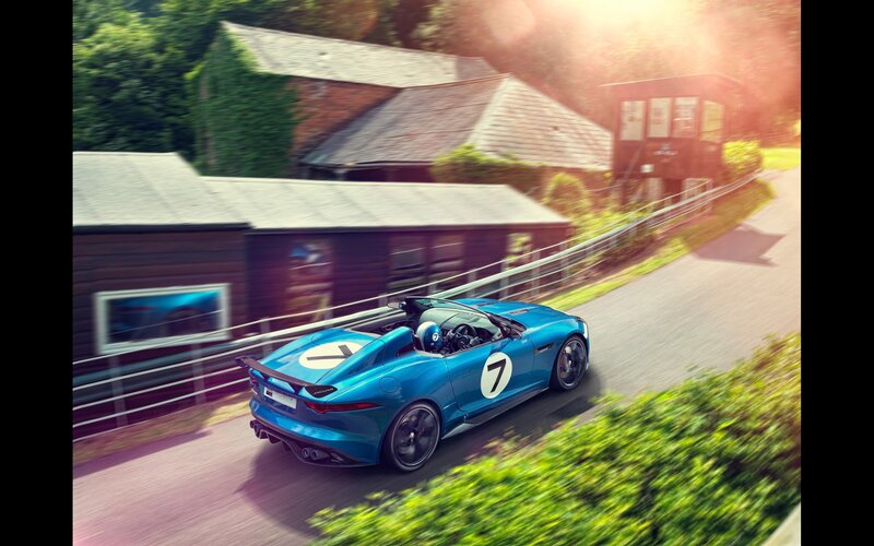 Blue Jaguar sports car on a country road