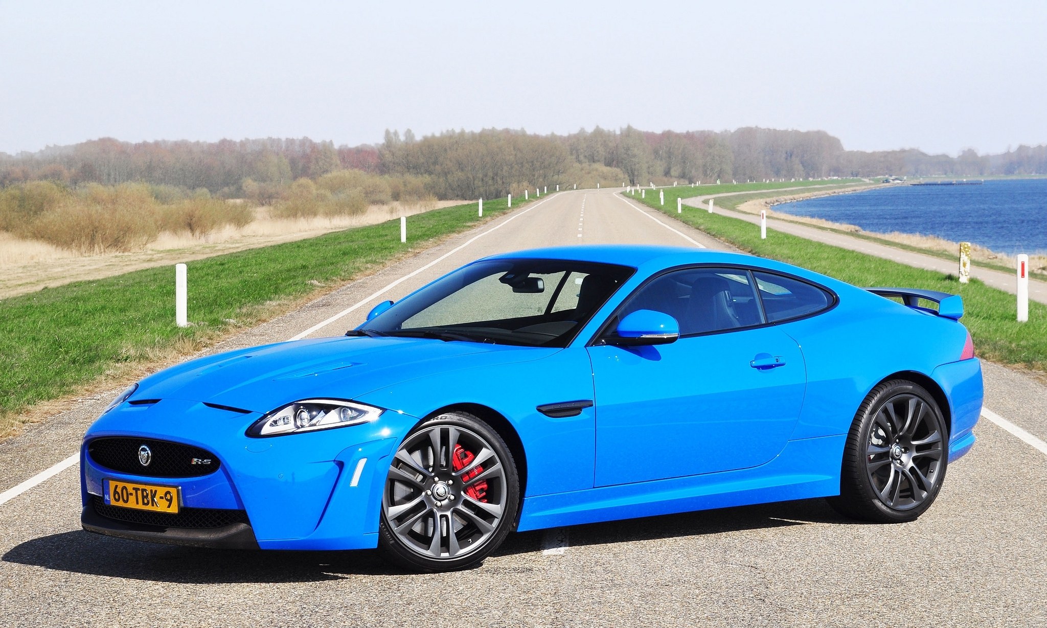 Blue Jaguar XKR-S on a country road