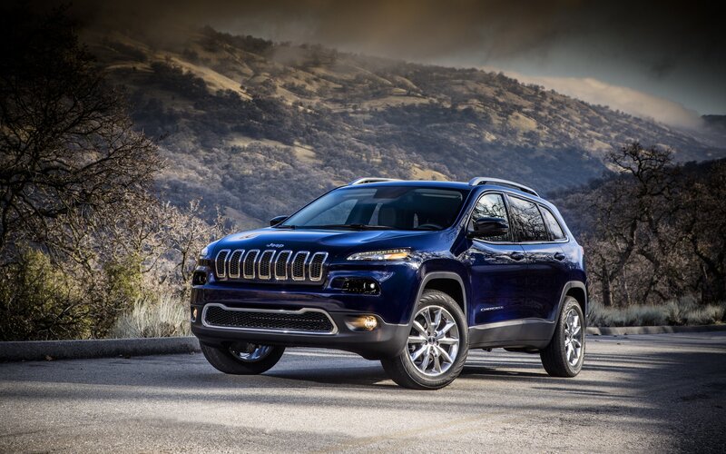 Blue Jeep Cherokee on a mountain road