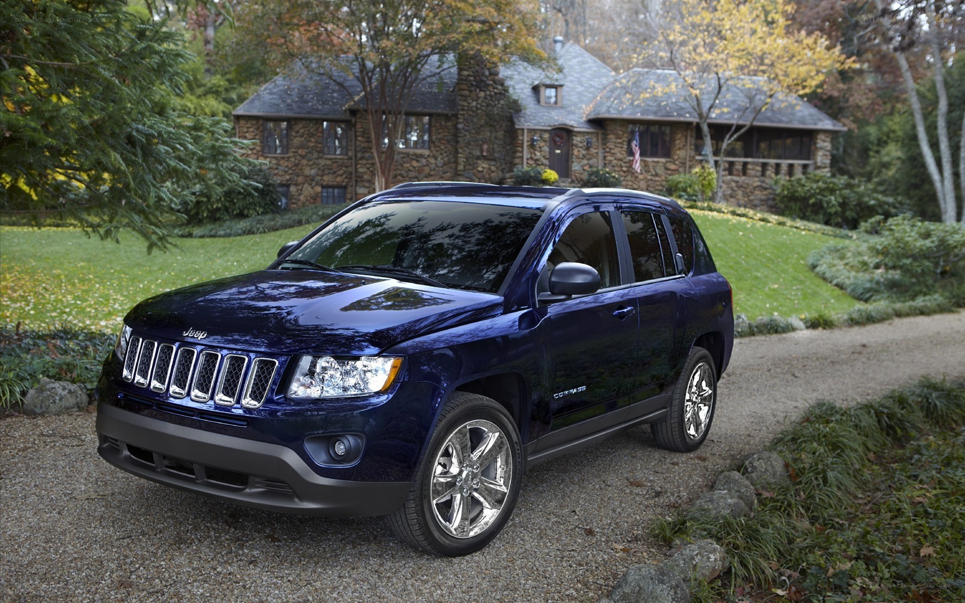 Blue Jeep Compass on a driveway