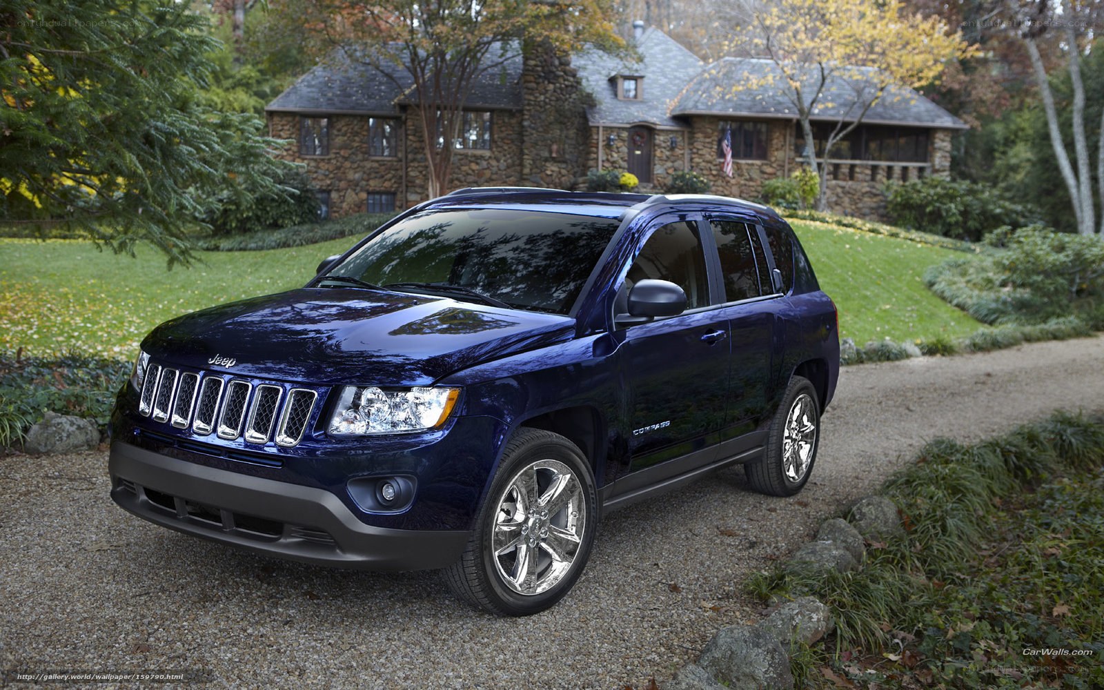 Blue Jeep Compass on gravel driveway