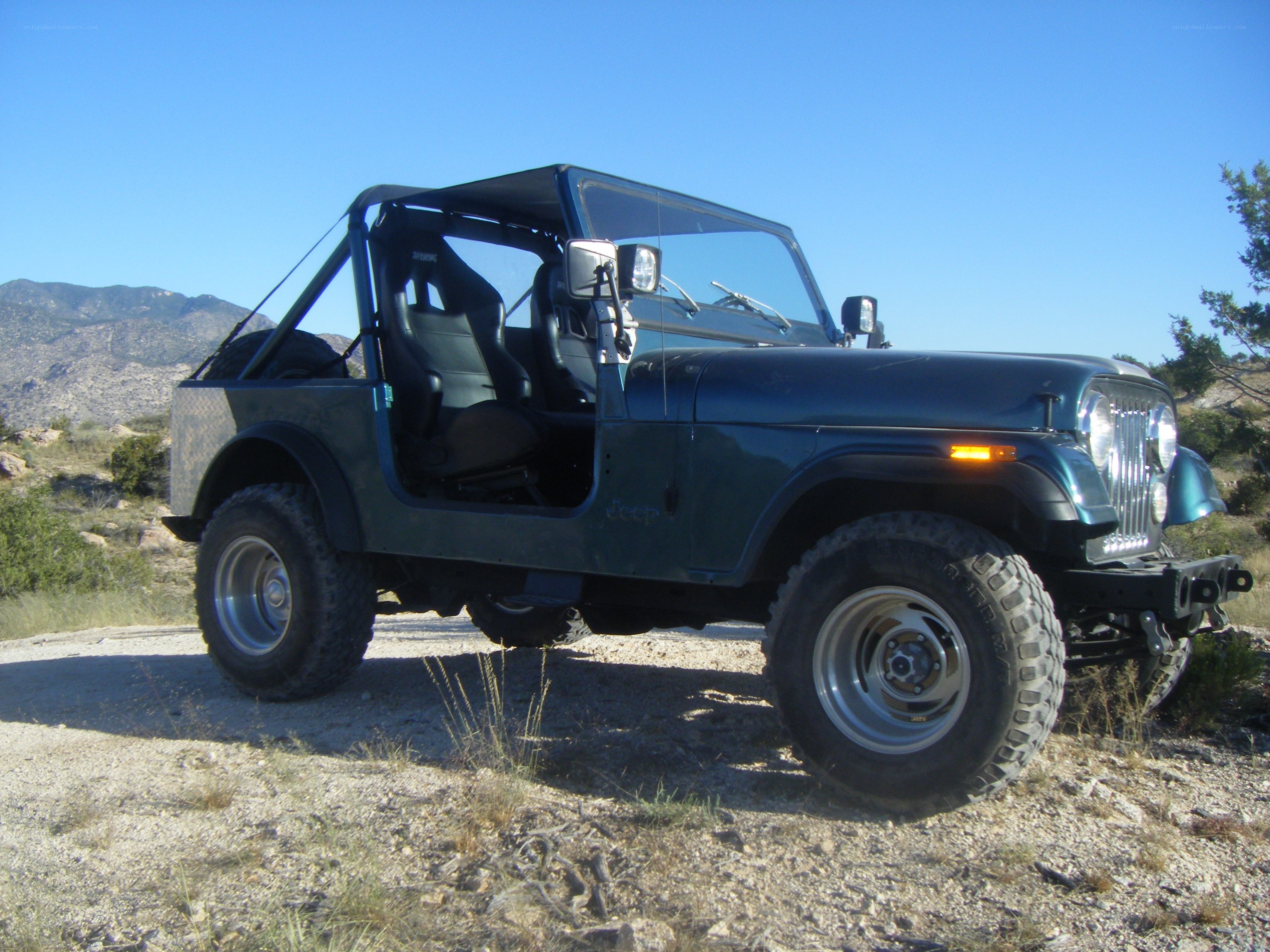 Blue Jeep in desert landscape