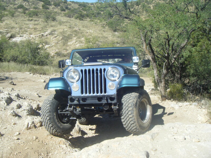 Blue Jeep on a rocky trail