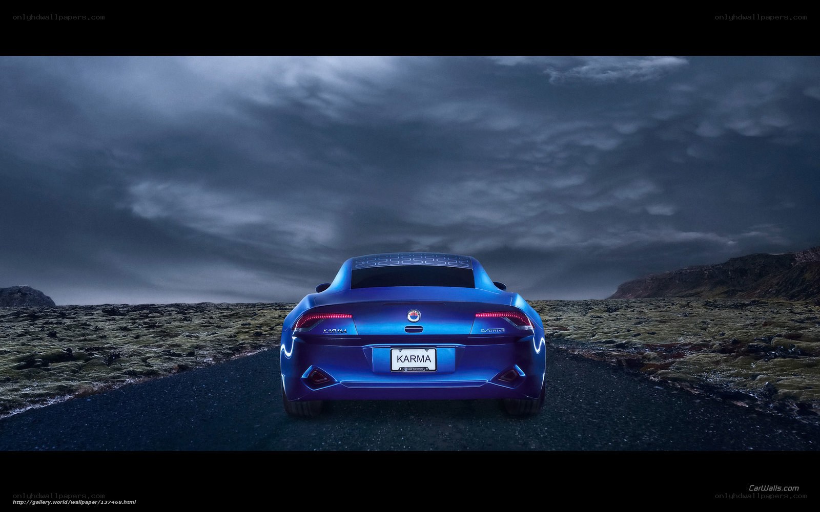 Blue Karma car on a dark road