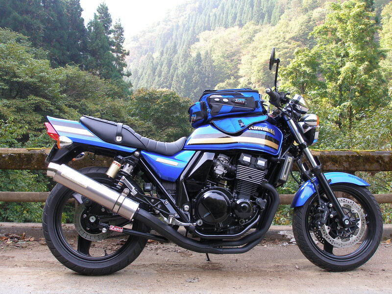 Blue Kawasaki motorcycle on a mountain road