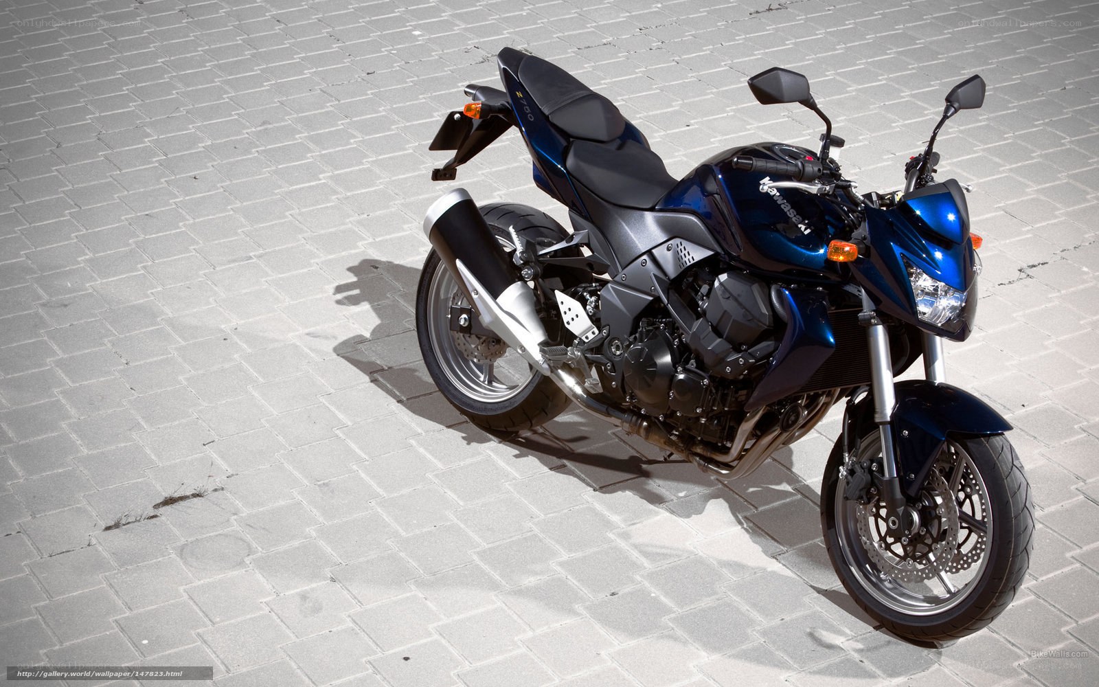 Blue Kawasaki motorcycle on pavement