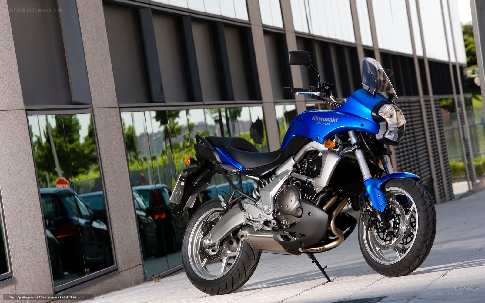 Blue Kawasaki motorcycle on sidewalk