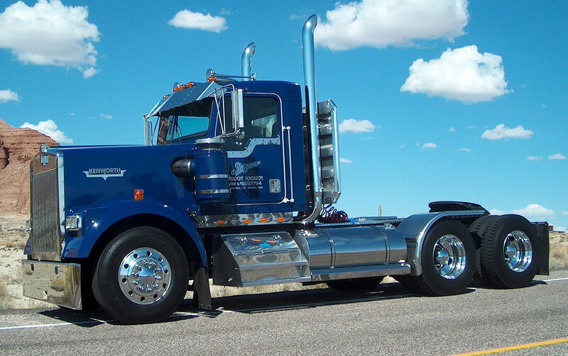 Blue Kenworth semi-truck on road