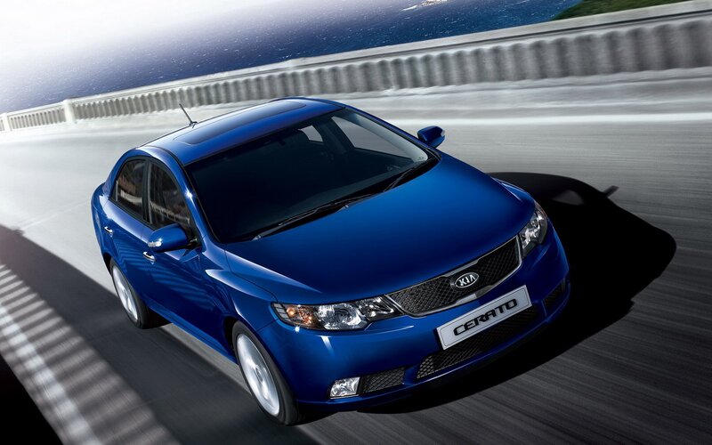 Blue Kia Cerato on a bridge