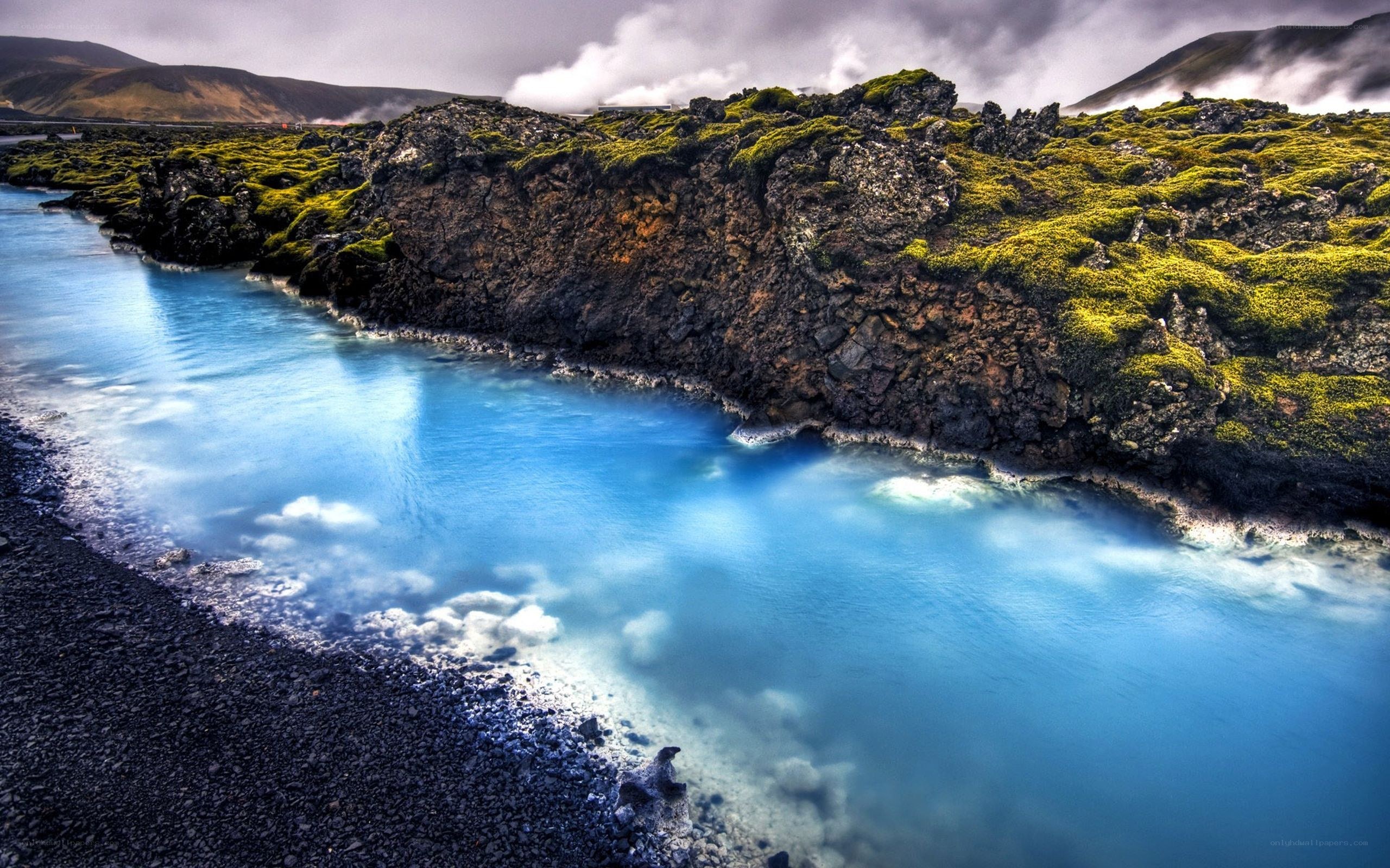 Blue lagoon with mossy cliffs