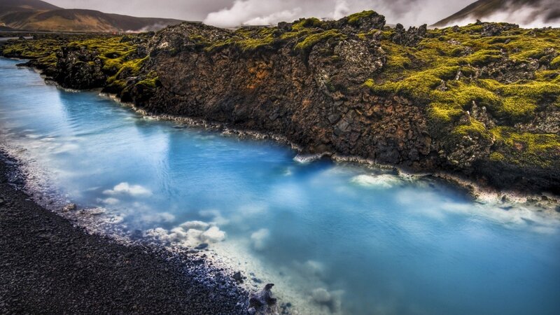 Blue lagoon with mossy cliffs