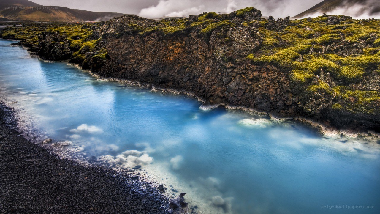 Blue lagoon with mossy cliffs