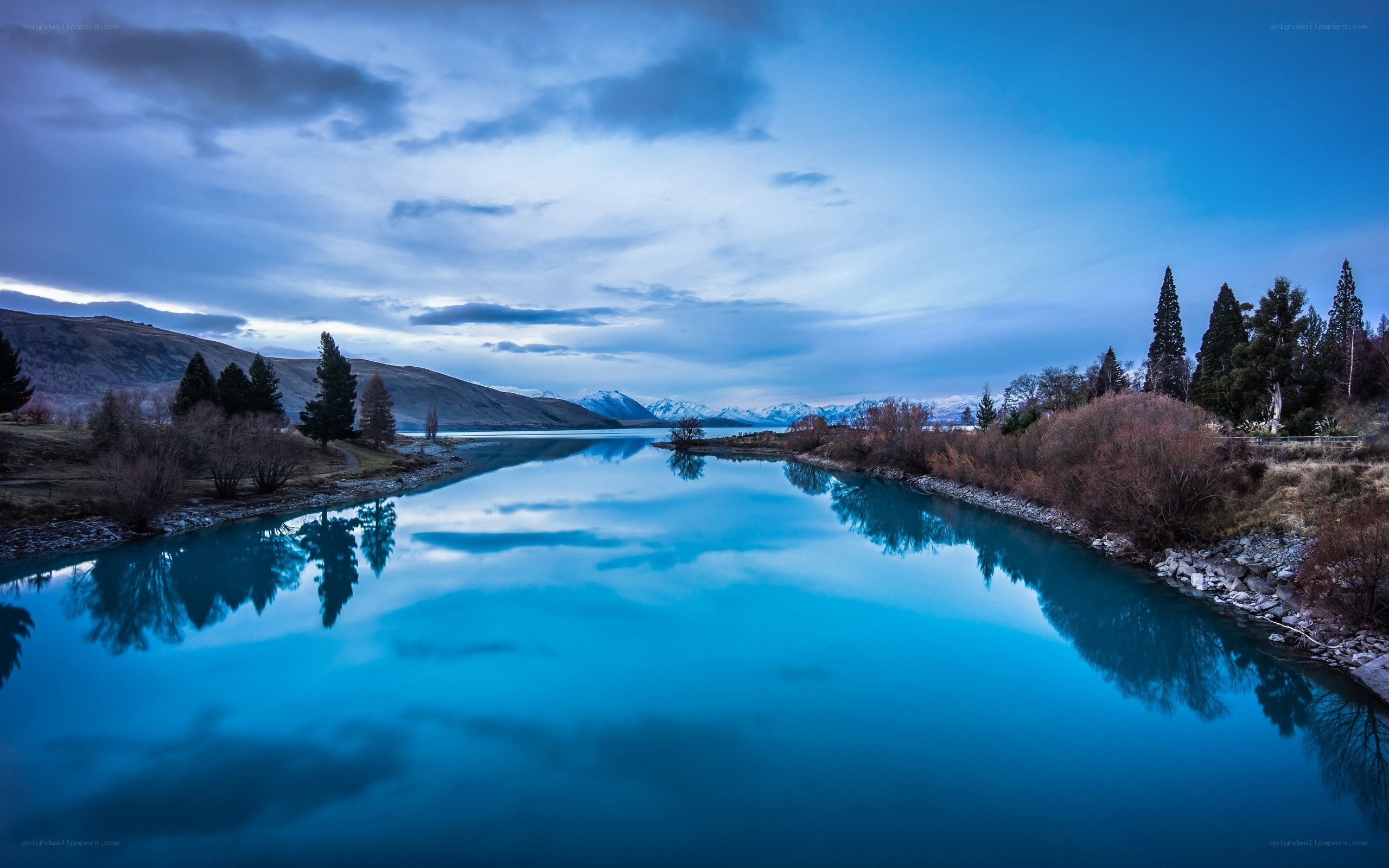 Blue lake at dusk with mountain reflection