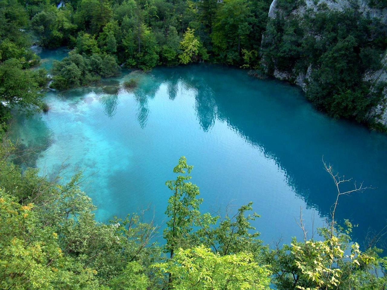 Blue lake in forested valley