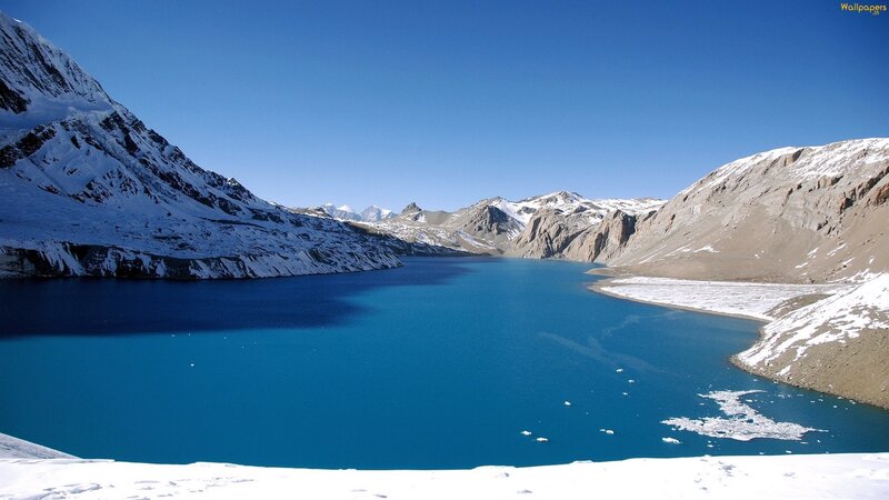blue lake in snowy mountains