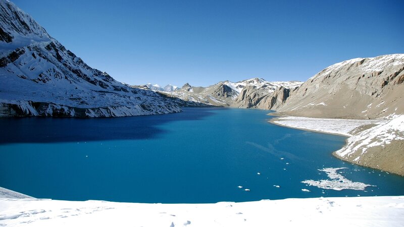 blue lake in snowy mountains