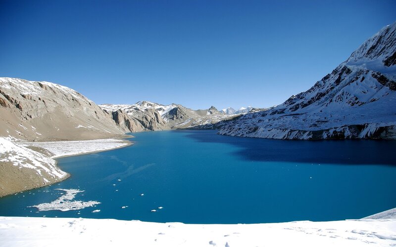 Blue lake in snowy mountains