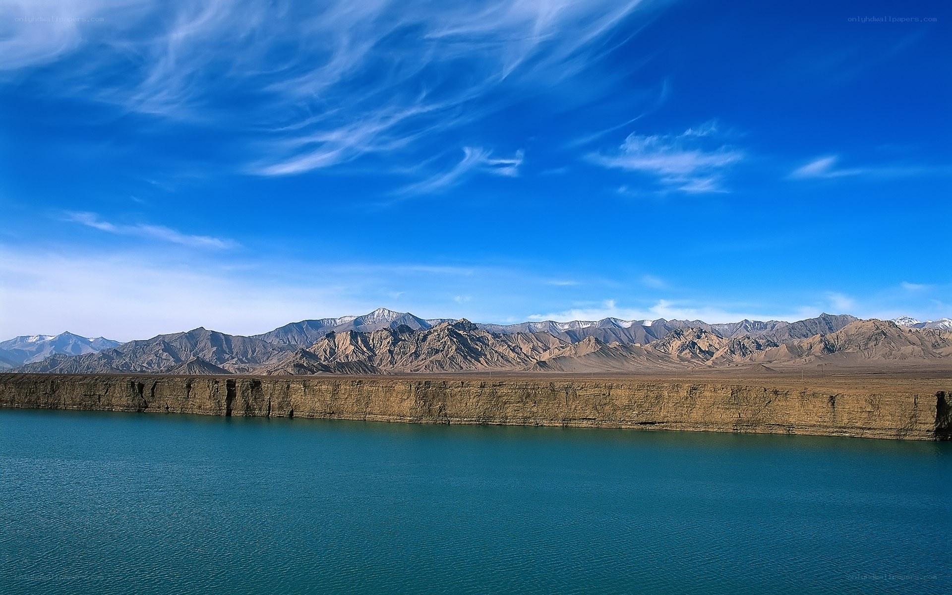 Blue lake with mountains in background