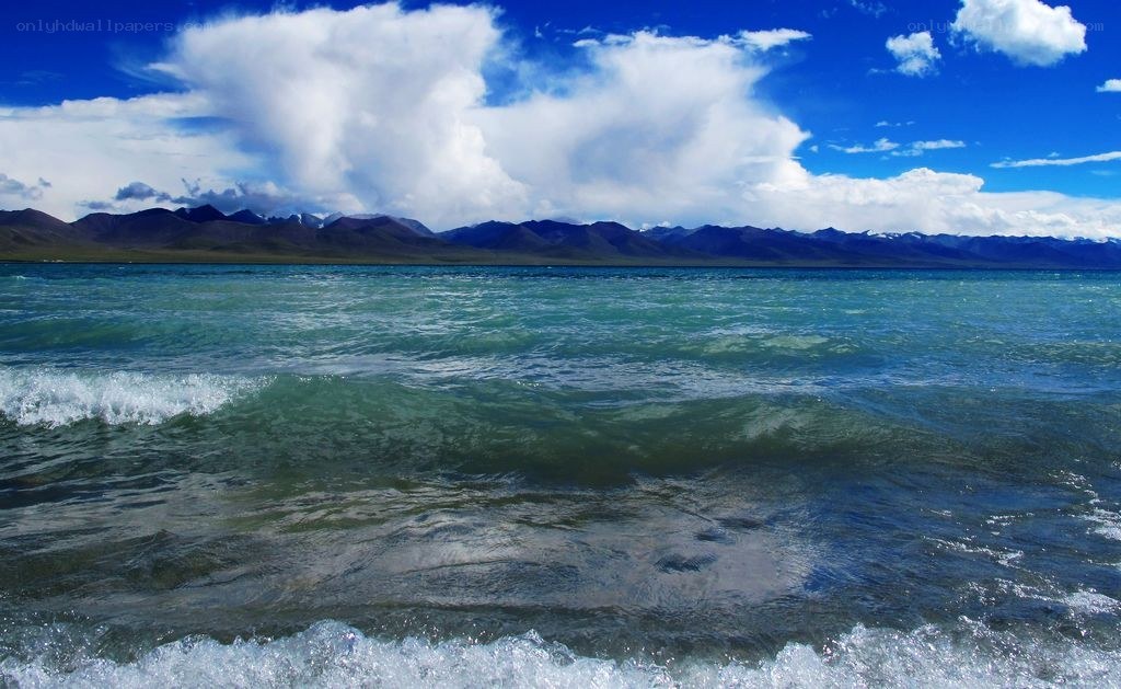 Blue lake with mountains in background