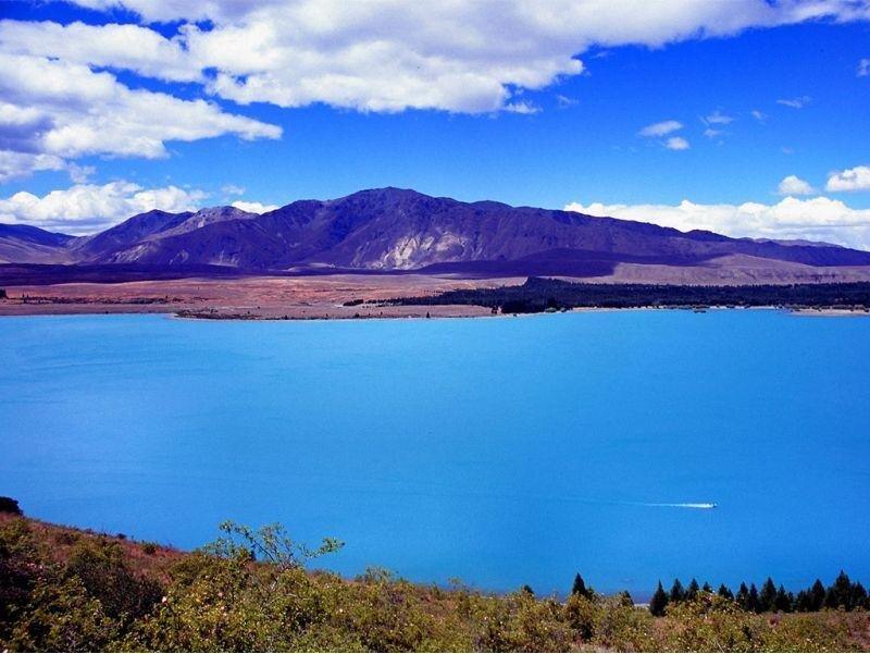 Blue lake with mountains in background