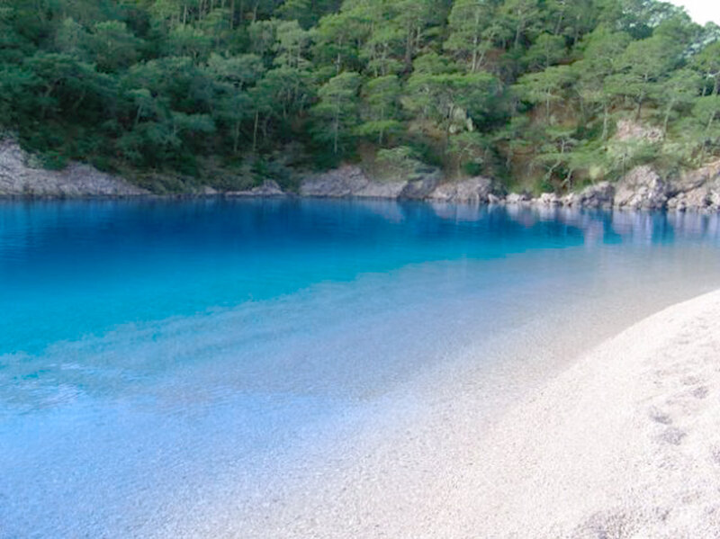 blue lake with sandy shore